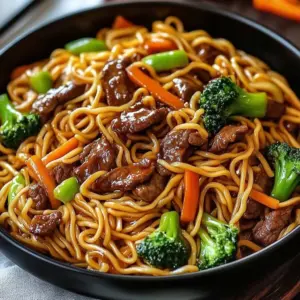 Delicious beef lo mein served in a bowl, garnished with vegetables and sauce.