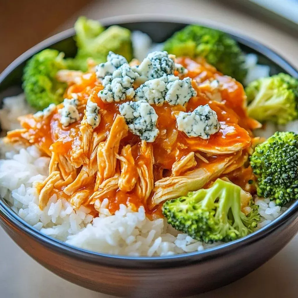 Spicy Buffalo Chicken Bowls topped with fresh ingredients and sauces